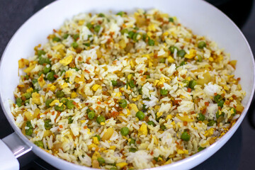 Vegan Thai fried rice with vegetables and tofu in a skillet cooked at home.