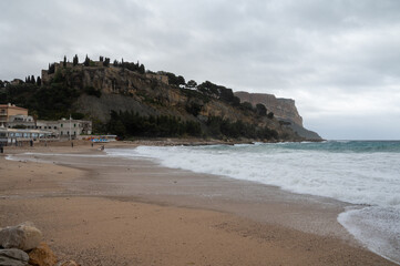 Stormy sea, high waves on yellow sandy beach in Cassis, Provence, France