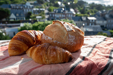 Two fresh baked butter croissants and whitre wheat farmers breasd from French bakery