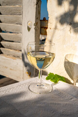 Glass of white wine from Cassis region served on outdoor terrace with view on old fisherman's...