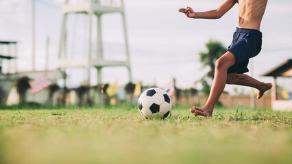 Action sport outdoors of kids having fun playing soccer football for exercise in community rural...