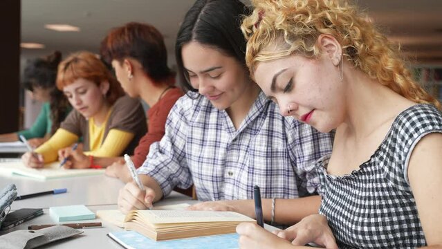 Young women working on project in library