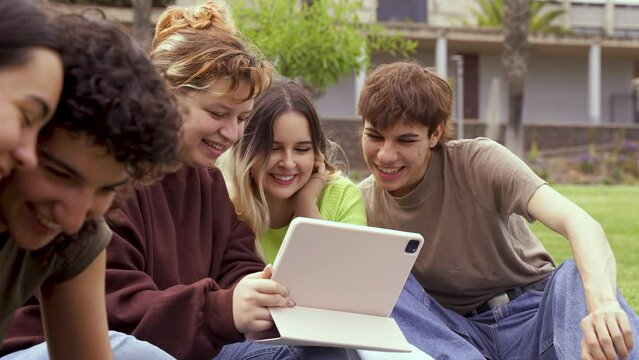 Cheerful friends using tablet computer