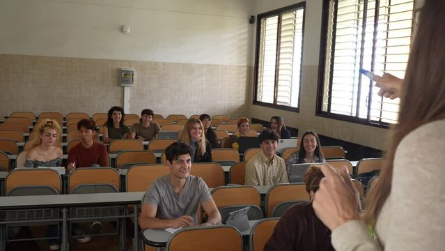 Faceless woman teaching students at class