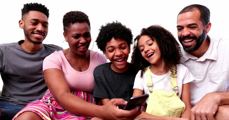 Obraz premium Happy mixed race family looking at phone device laughing and smiling