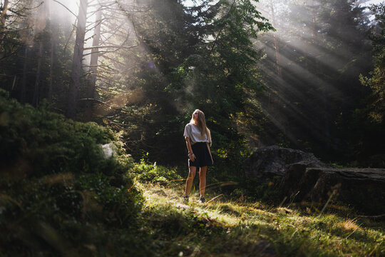 Woman hiker walking in forest