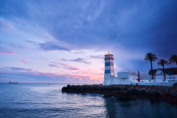 Fototapeta na wymiar Farol Museu de Santa Marta. Lighthouse and Museum in Cascais, Portugal. Beautiful sunset on the sea shore.