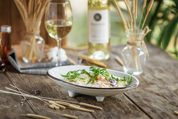 Portion of gourmet seafood risotto on wooden background