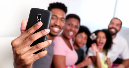 Obraz premium Happy black family taking selfie photo with smartphone