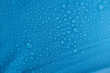 Rain drops on a blue umbrella	