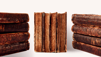 Stacks of old worn shabby books in leather binding isolated on white background. Banner. Selective focus.