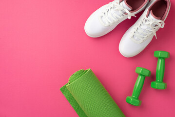 Sports accessories concept. Top view photo of white sports footwear green yoga mat and dumbbells on...