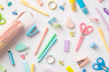 School supplies concept. Top view photo of scattered stationery correction pens pink pencil-case...