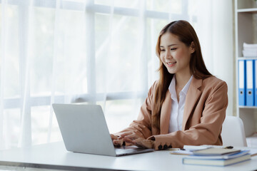 Beautiful Asian woman running a company, businesswoman who founded a new generation of startup companies, management run by female leaders, female bosses. Business administration concept.