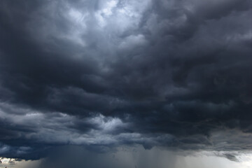 The dark sky with heavy clouds converging and a violent storm before the rain.Bad or moody weather...