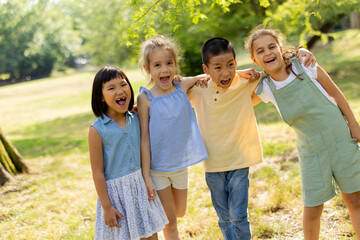 Group of asian and caucasian kids having fun in the park