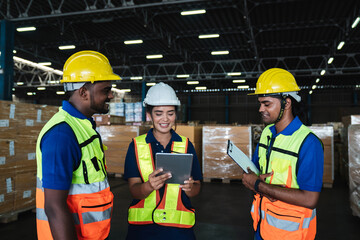 Warehouse workers checking details work on a tablet in the background warehouse., Industrial and industrial concept.