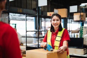 Warehouse worker checking and scanning a barcode on box package in the background warehouse.,...