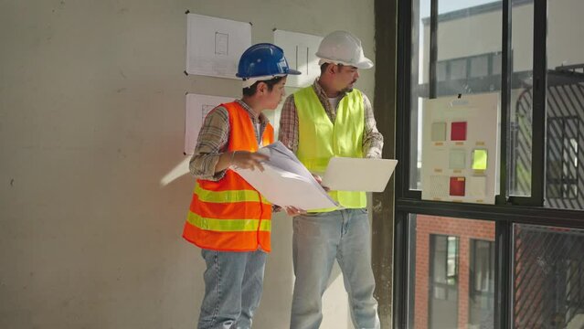 Asia architects and engineer planning of house renovation with blueprint indoor,home interior designer,working confliction,real estate development industries.