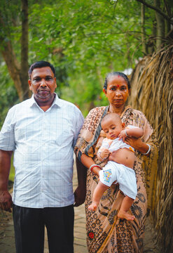 South asian family picture . happy bangladeshi hindu family in a village outdoor environment. 