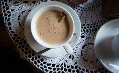 Delicious cup of hot chocolate with two sticks of fresh cinnomin