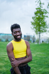 Portrait of young man with makeup outdoors and yellow t-shirt