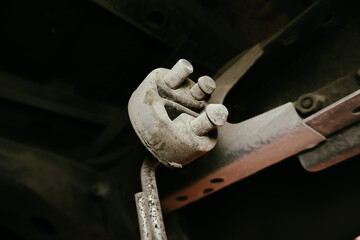 Exhaust rubber mount with a mud stain on a automobile