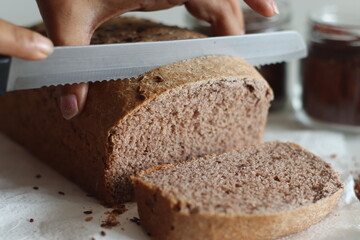 Ragi bread or Finger millet bread. Loaf of home baked bread with finger millet flour sprinkled with...