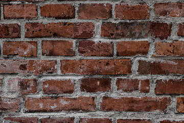 close-up of old wall with red bricks and concrete. Abstract background texture.