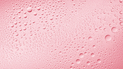 Water drops on the wet glass surface on pink background | Background for skin care moisturizing products