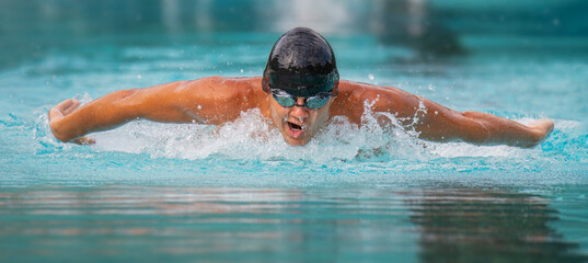 Male athlete swimming butterfly stroke