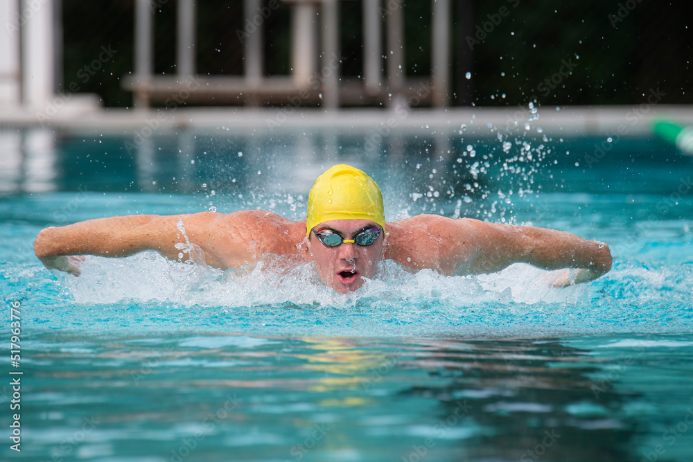 Wall mural male swimmer doing butterfly stroke