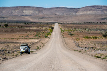 Obraz na płótnie Canvas Camper on a gravel road in Namibia Africa