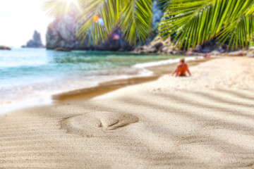 Fototapeta na wymiar Beach sand with sun shadows and an open space on a lovely hot holiday day