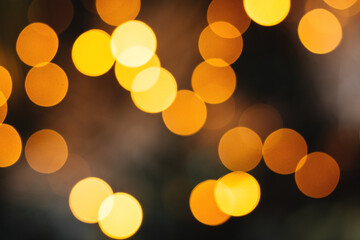 Defocused bright abstract holiday background with yellow and orange twinkling sunspots. Bokeh Copy space for text. Merry Christmas and Happy New Year