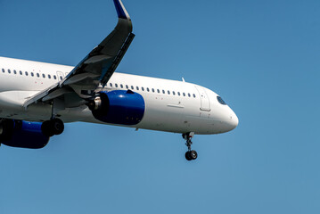 Fototapeta na wymiar Close-up of modern airplane over blue sky