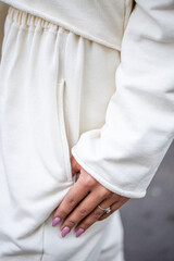 the girl's hand in the pocket of sportswear close-up.