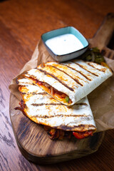 two tortillas with filling and sauce top view