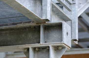 beam architecture: detail of a structure built with steel beams joined with bolting to support a staircase for emergency exits in a public building.