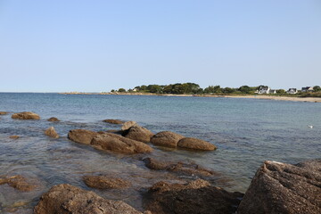 rock in the sea at the beach with blue sky