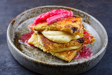 Traditional roasted Italian panettone tiramisu with vanilla custard curd and rhubarb served as...