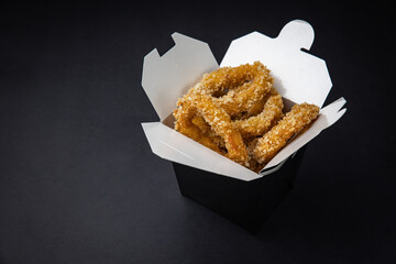 squid rings in batter on a dark background
