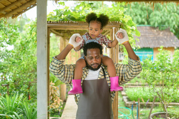 Happy Mixed race father and little girl agronomist  enjoying and working in farmland, agriculture concept