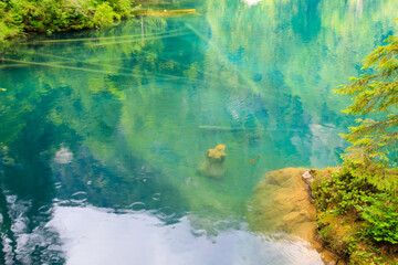 Underwater statue of young girl in Blausee lake (Blue Lake) in Bernese Oberland, Kandergrund, Switzerland
