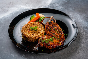 cajun chicken with fried rice served in a dish isolated on dark background side view food