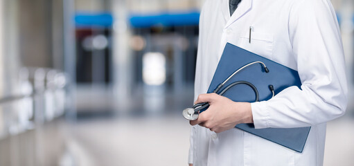 Doctor holding documents in his hands .