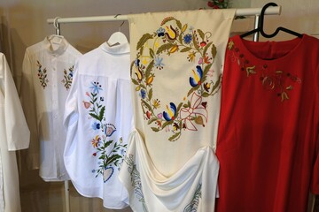 Shirts and tablecloths with traditional Kashubian embroidered patterns - obrazy, fototapety, plakaty