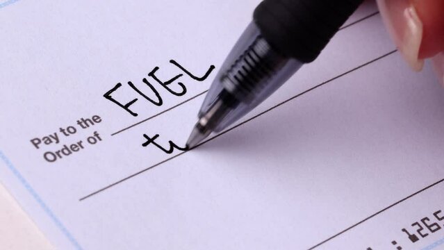 Close-up shot of a check being writen.
