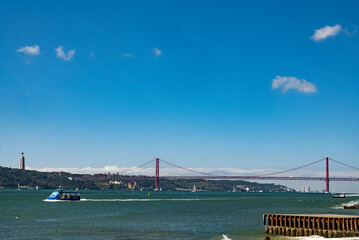 Lisboa, Portugal. April 9, 2022: View of the river Tagus and bridge November 25 with blue sky. 