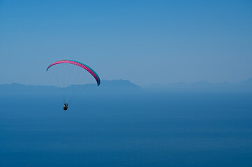 Paraglider flying on Oren beach in Milas, Mugla. Travel destination. Summer and holiday concept.